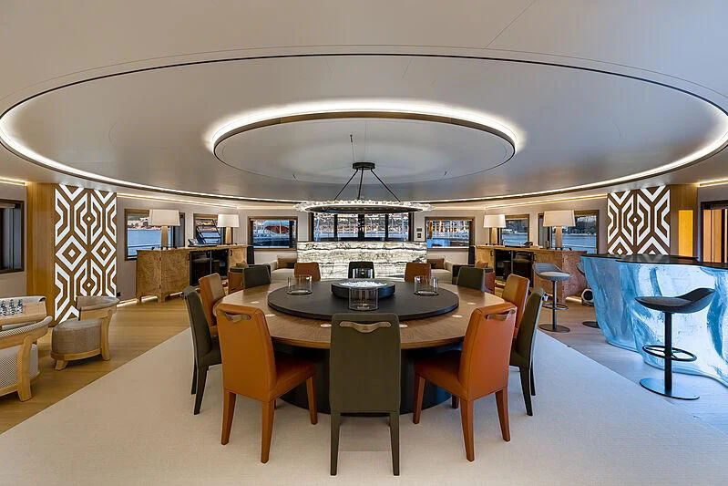 a room with tables and chairs aboard LA DATCHA Yacht for Sale