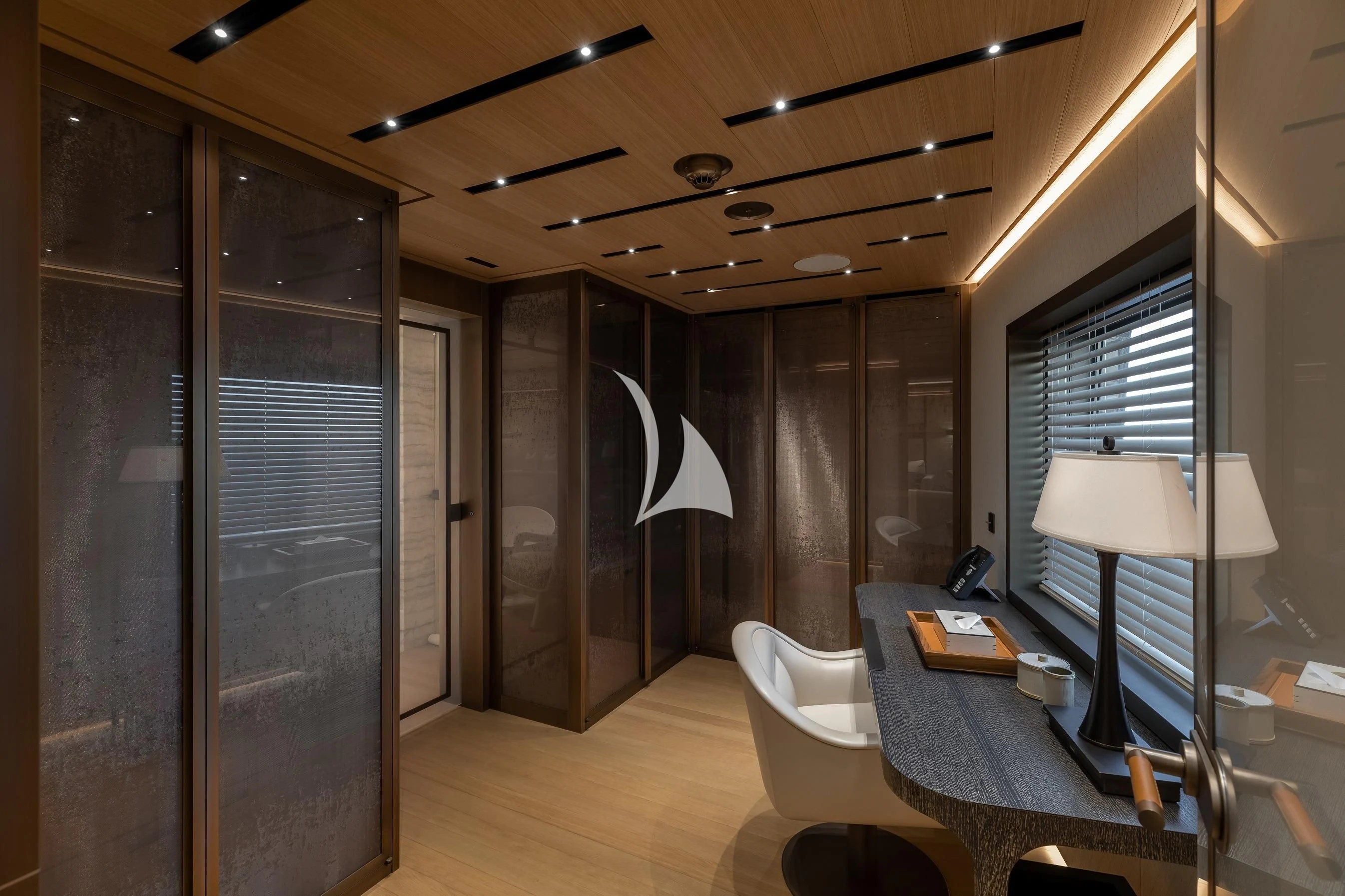 a room with a desk and a lamp aboard LA DATCHA Yacht for Sale