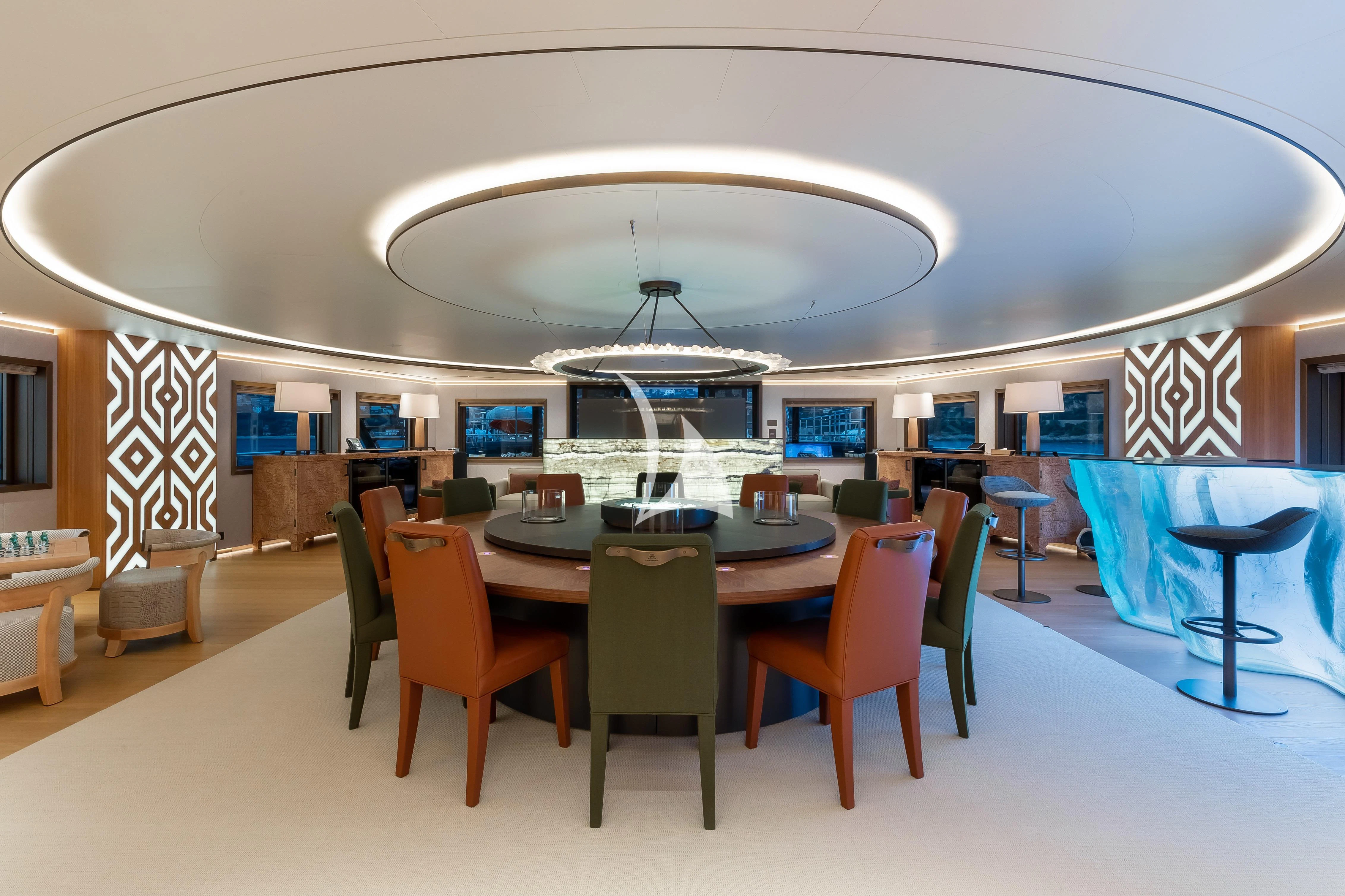 a room with tables and chairs aboard LA DATCHA Yacht for Sale