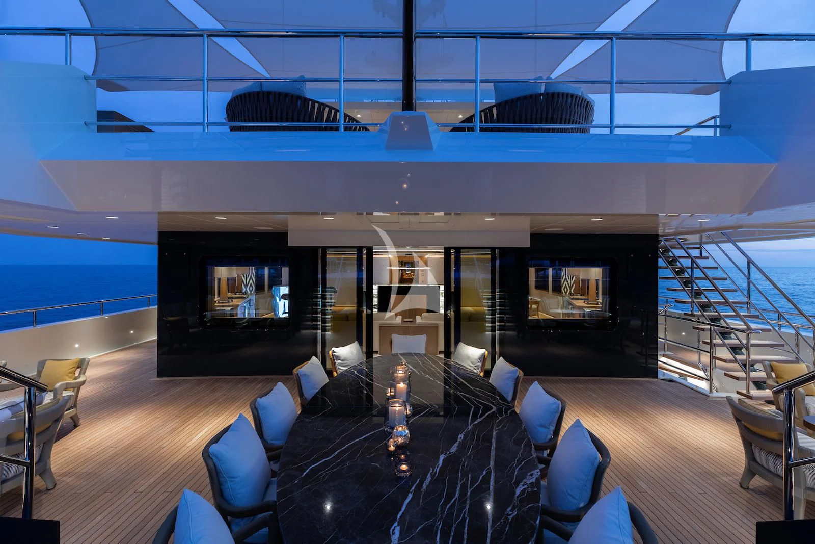 a room with a black couch and a large screen with a black sofa and a black table with aboard LA DATCHA Yacht for Sale