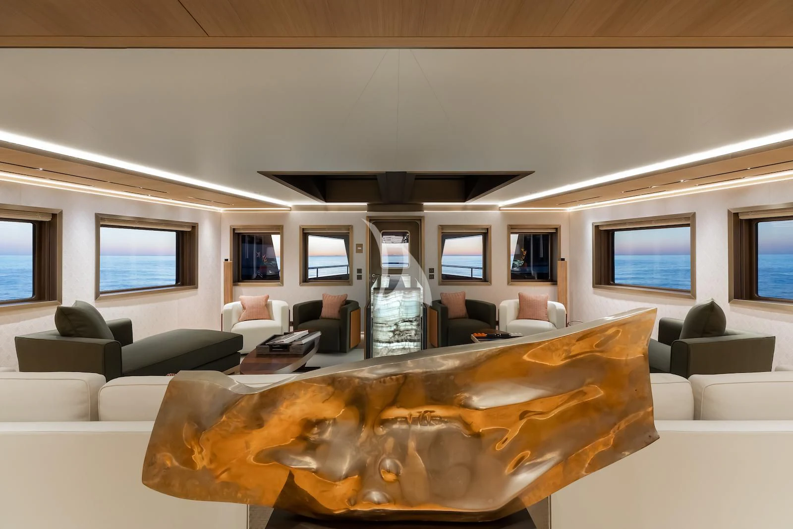a living room with a large glass bottle on the table aboard LA DATCHA Yacht for Sale