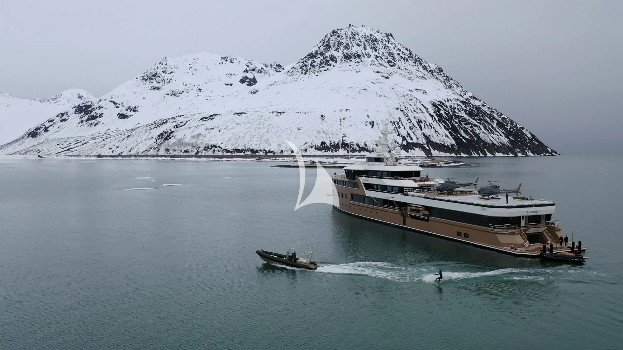 a couple of boats on the water with a mountain in the background aboard LA DATCHA Yacht for Sale
