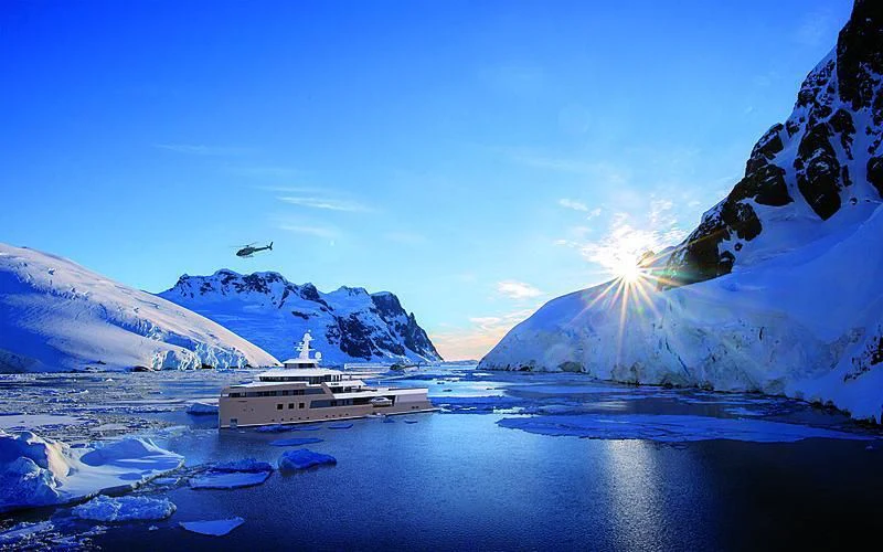 a boat in the water with mountains in the background aboard LA DATCHA Yacht for Sale