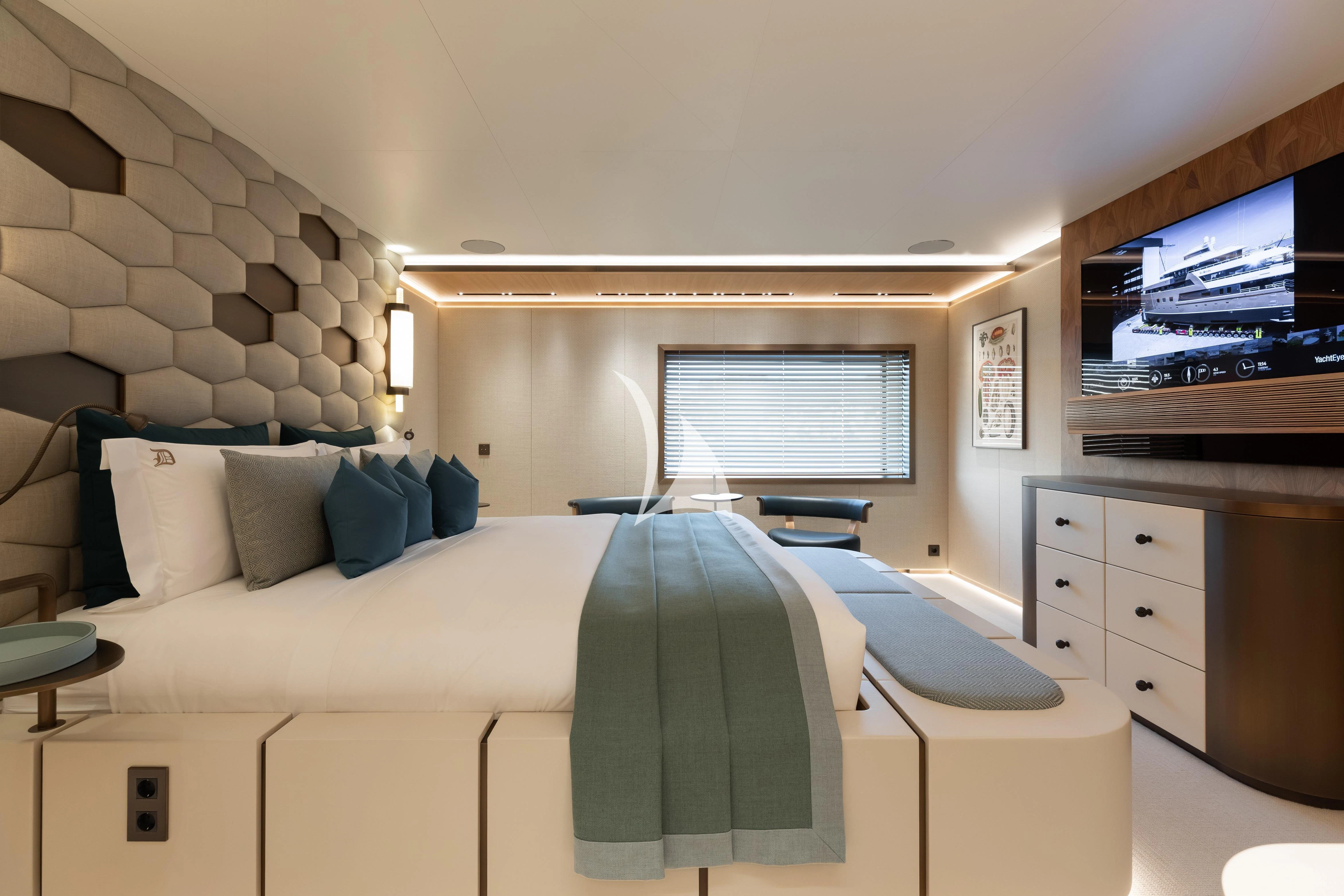 a bed with a blue blanket aboard LA DATCHA Yacht for Sale