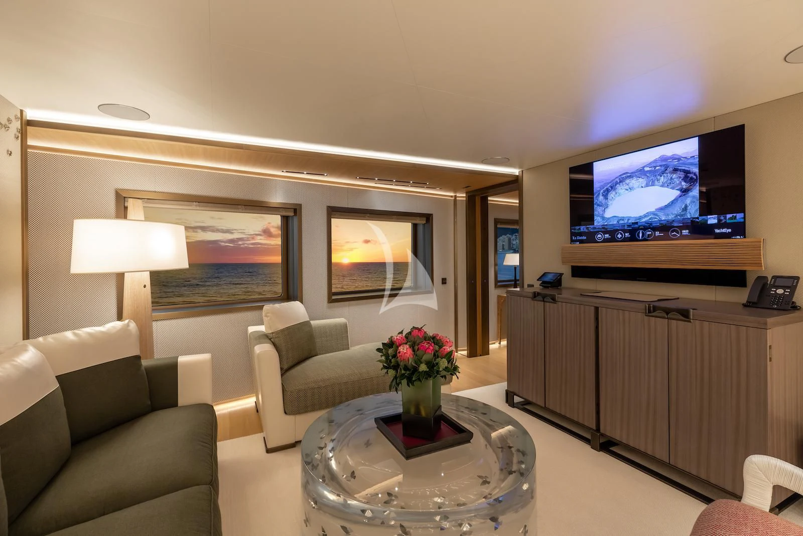 a living room with a tv and a table aboard LA DATCHA Yacht for Sale