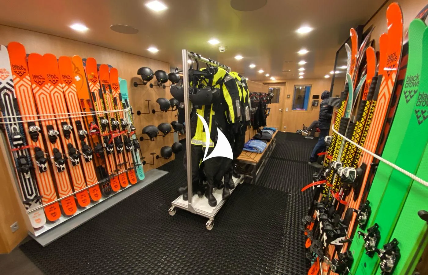 a group of people in a room with a large display of hockey jerseys aboard LA DATCHA Yacht for Sale