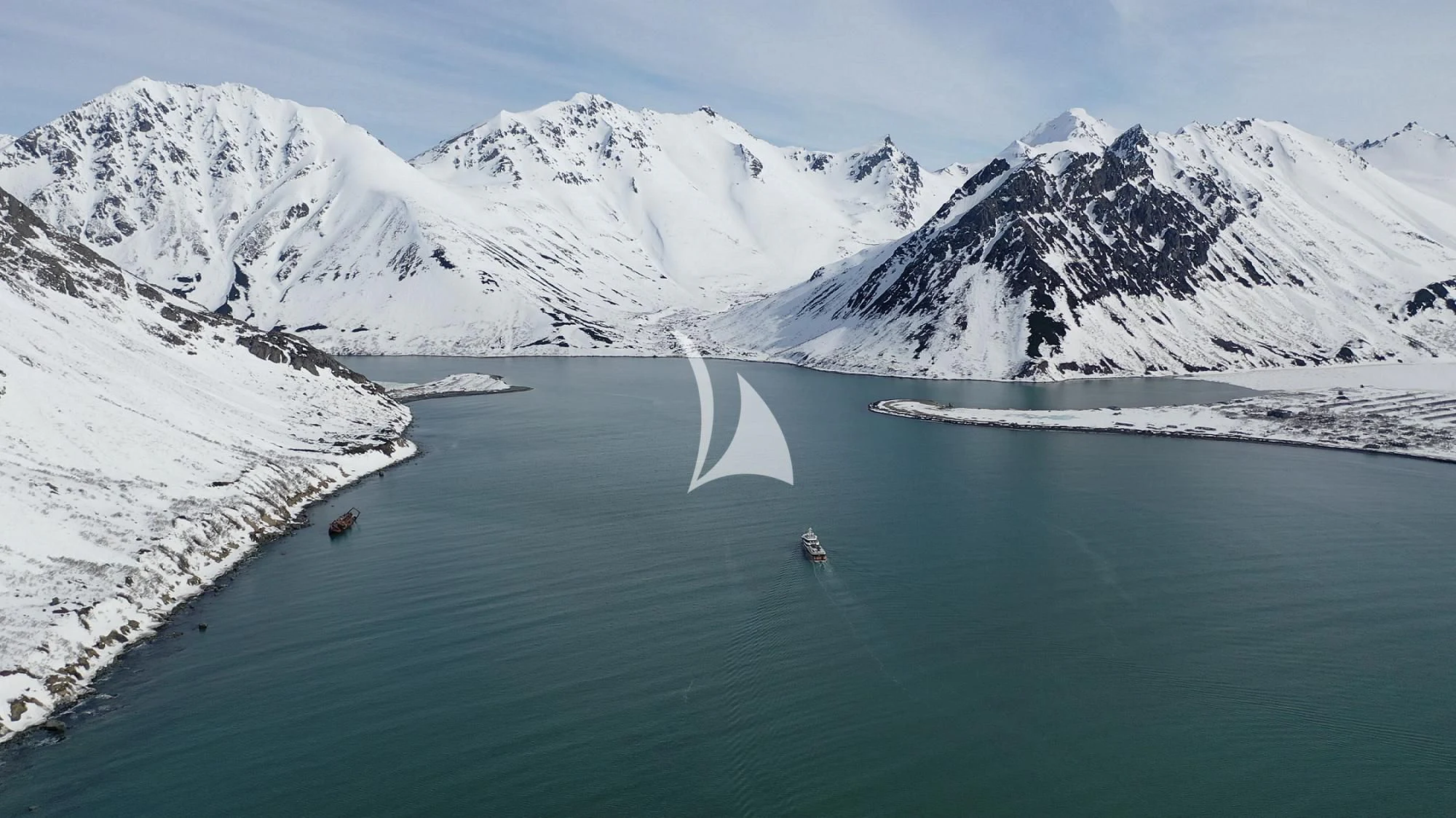 a body of water with mountains in the background aboard LA DATCHA Yacht for Sale