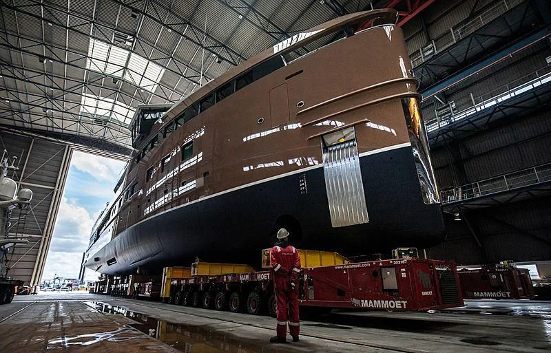 a person standing in front of a large ship aboard LA DATCHA Yacht for Sale
