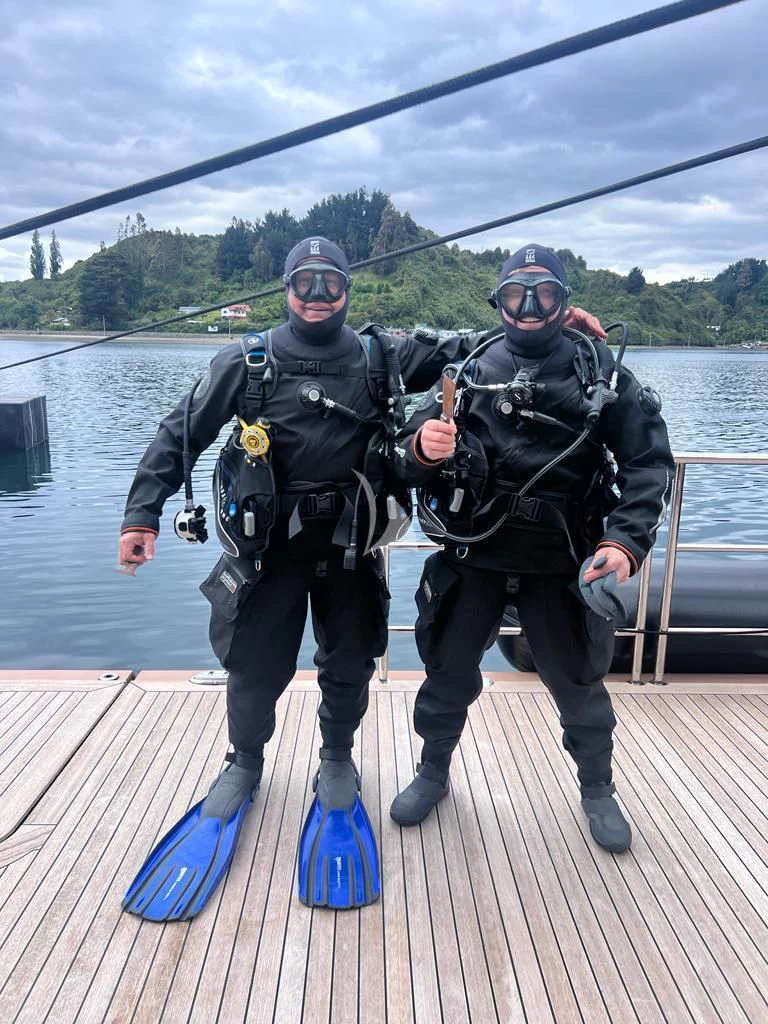 a couple of men posing for a picture on a dock aboard LA DATCHA Yacht for Sale
