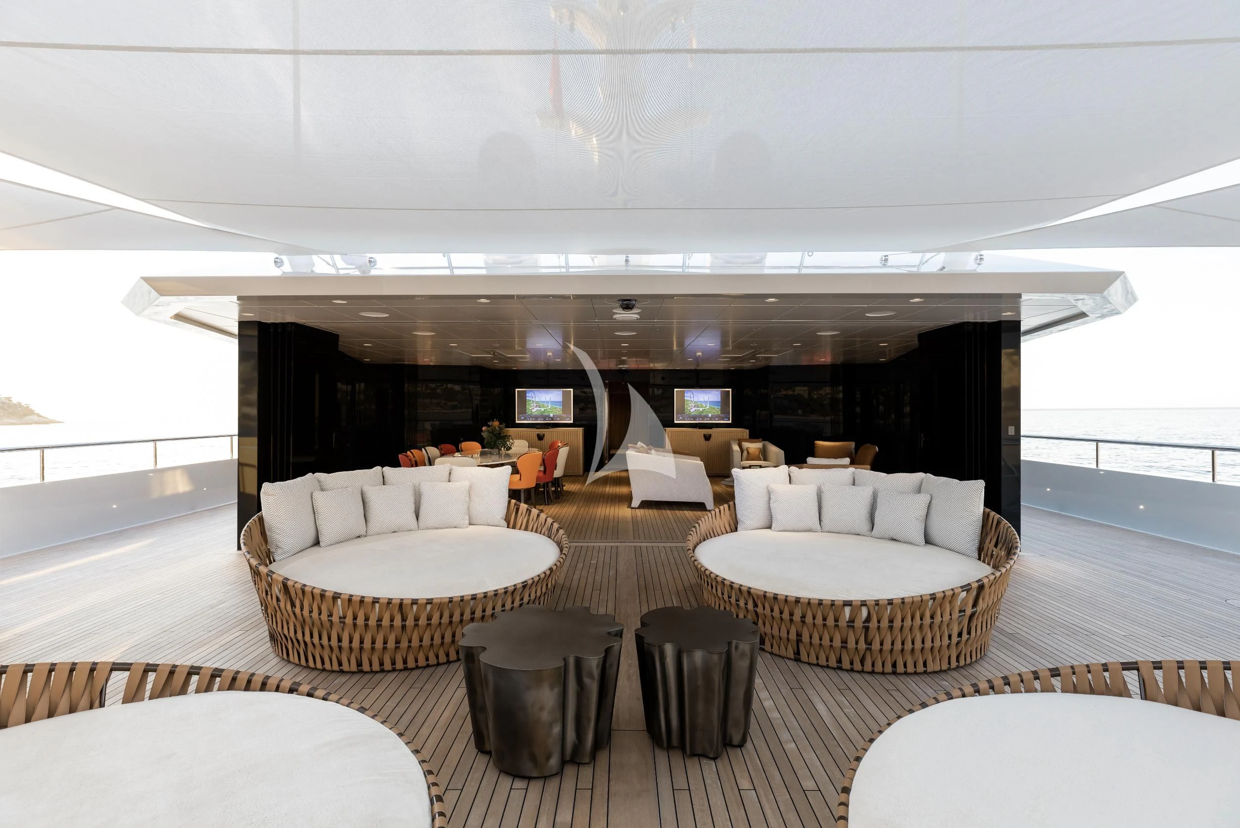 a room with a table chairs and a couch aboard LA DATCHA Yacht for Sale