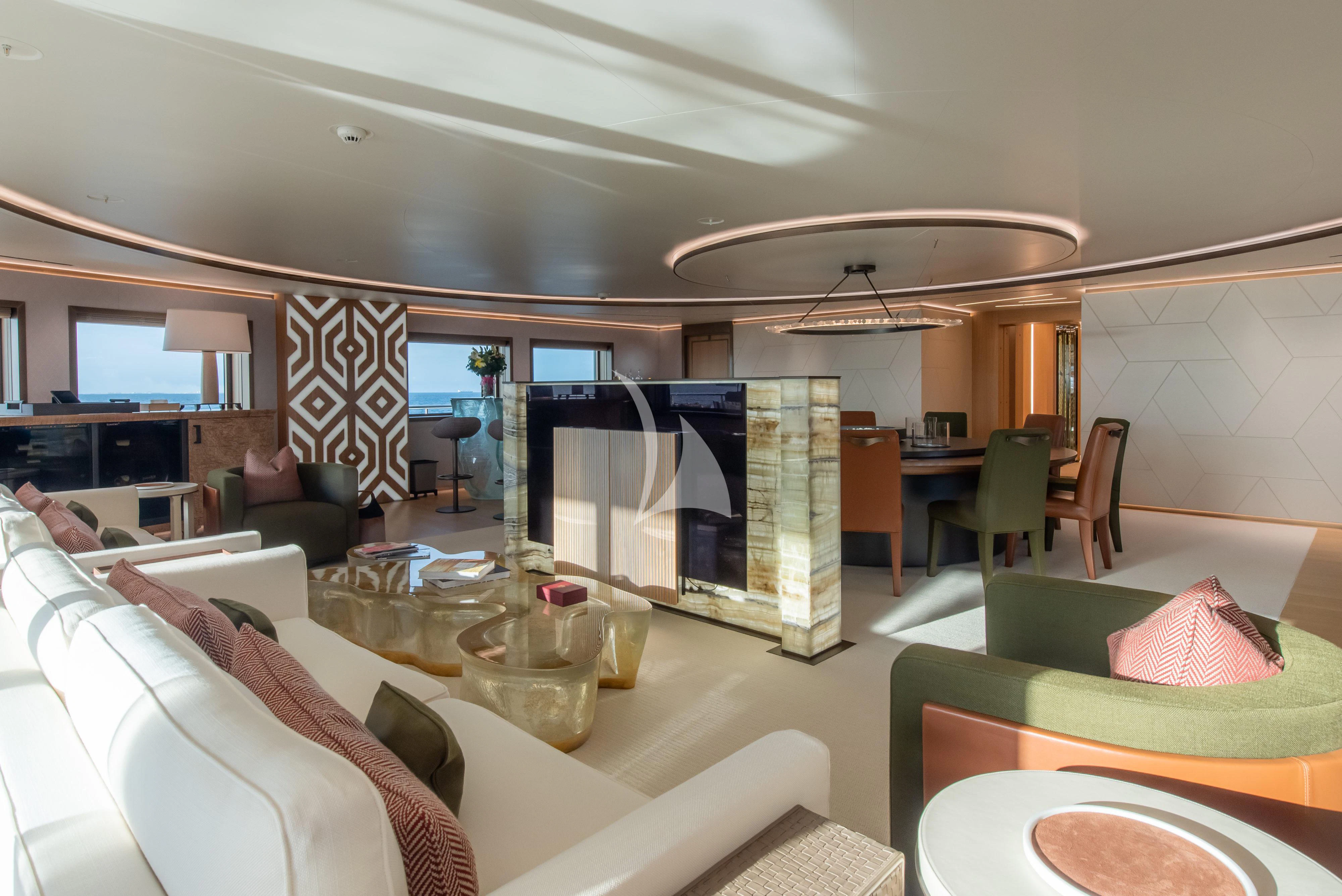a room with a table chairs and a television aboard LA DATCHA Yacht for Sale