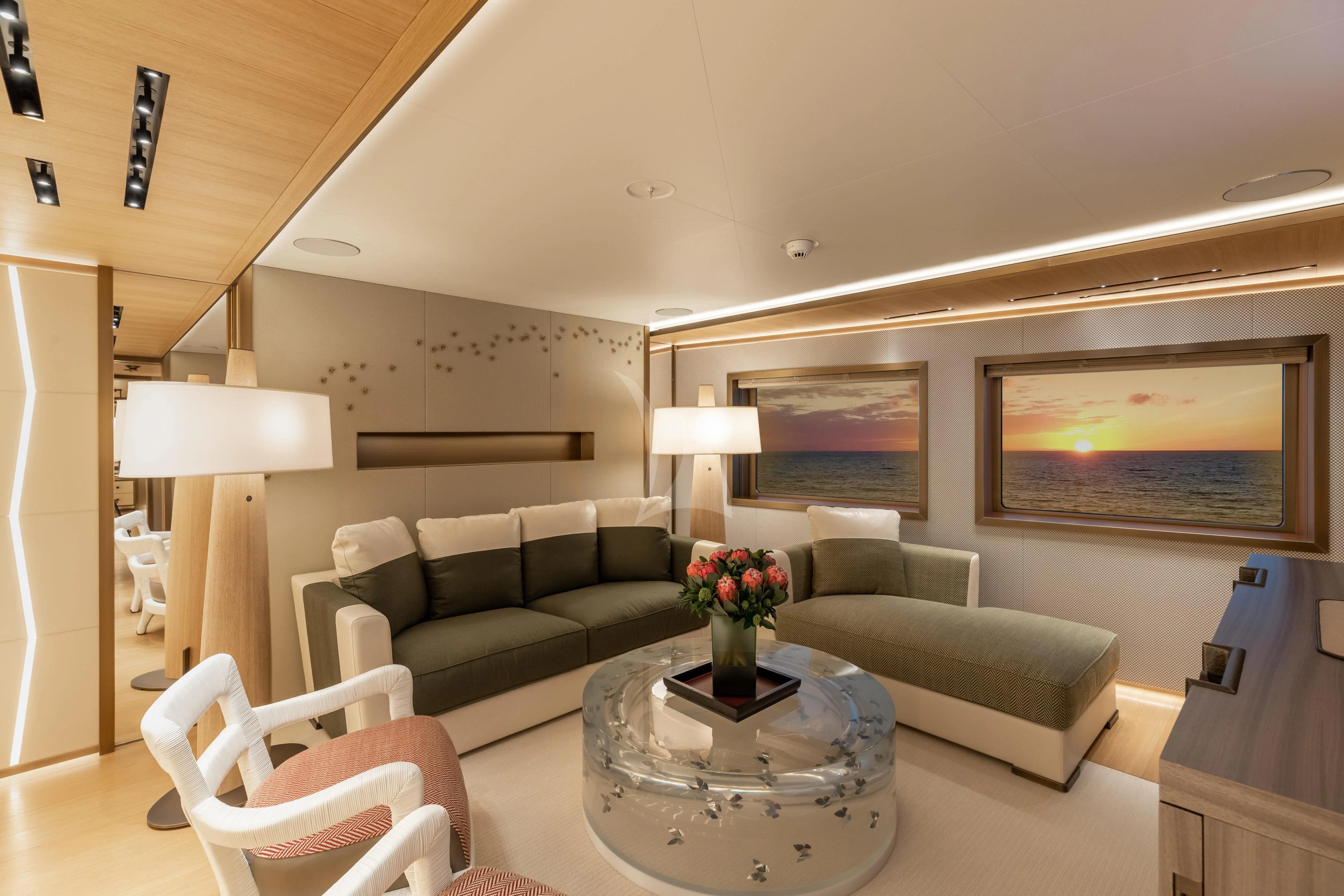 a living room with a couch and a coffee table aboard LA DATCHA Yacht for Sale