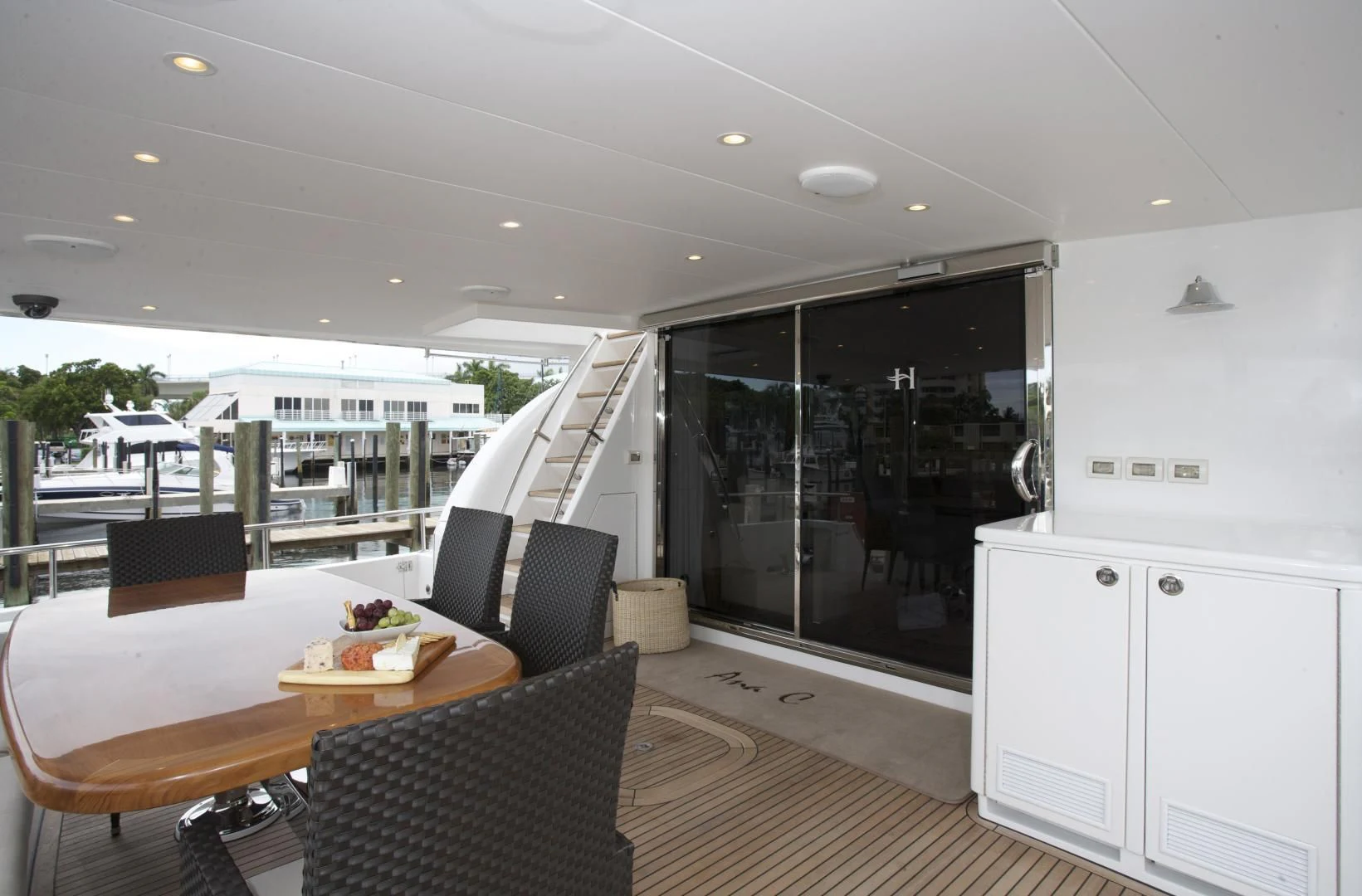 a large open area with a table and chairs and a large window aboard LADY C II Yacht for Sale