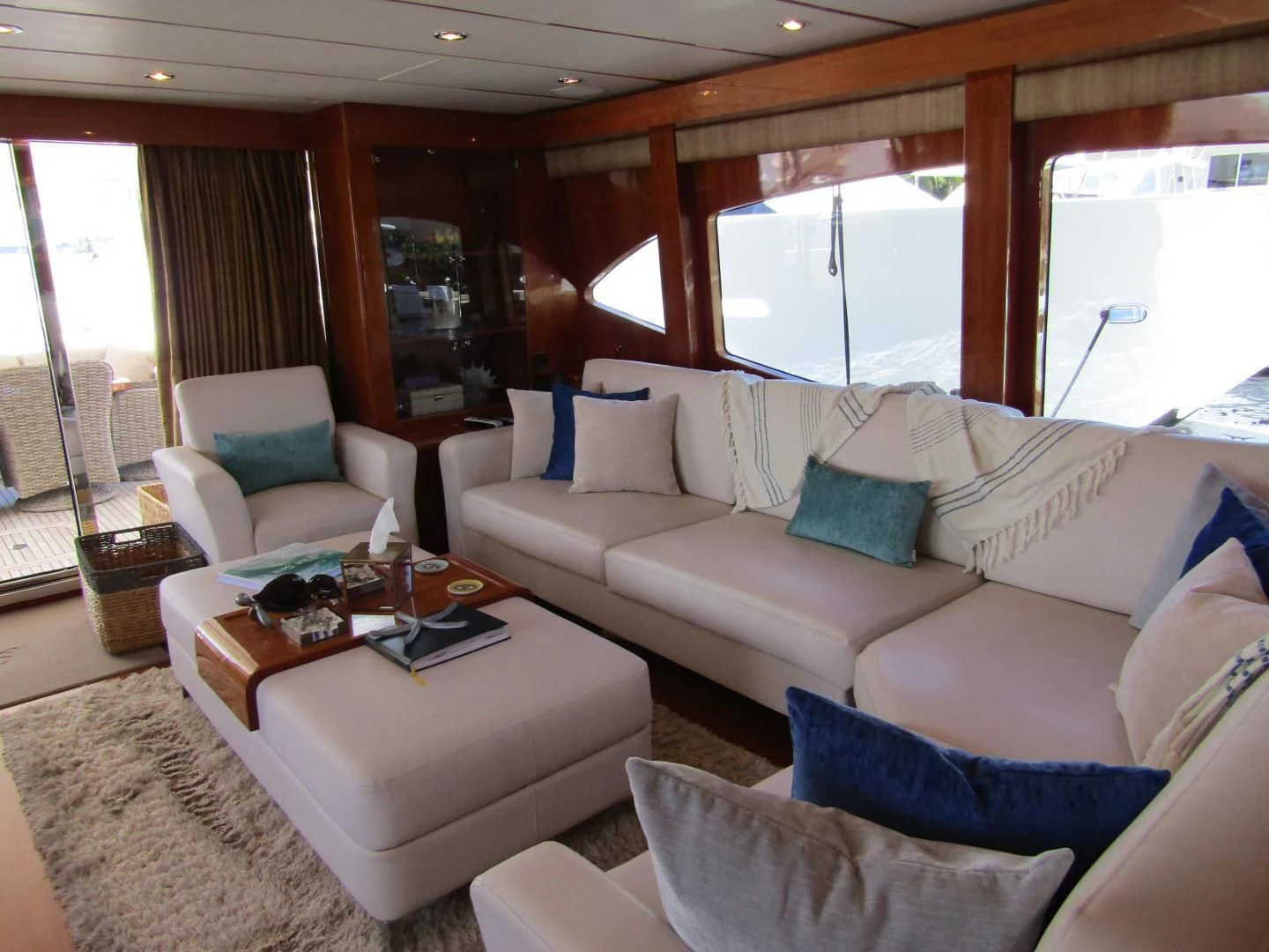 a living room with a couch and a coffee table aboard LADY C II Yacht for Sale