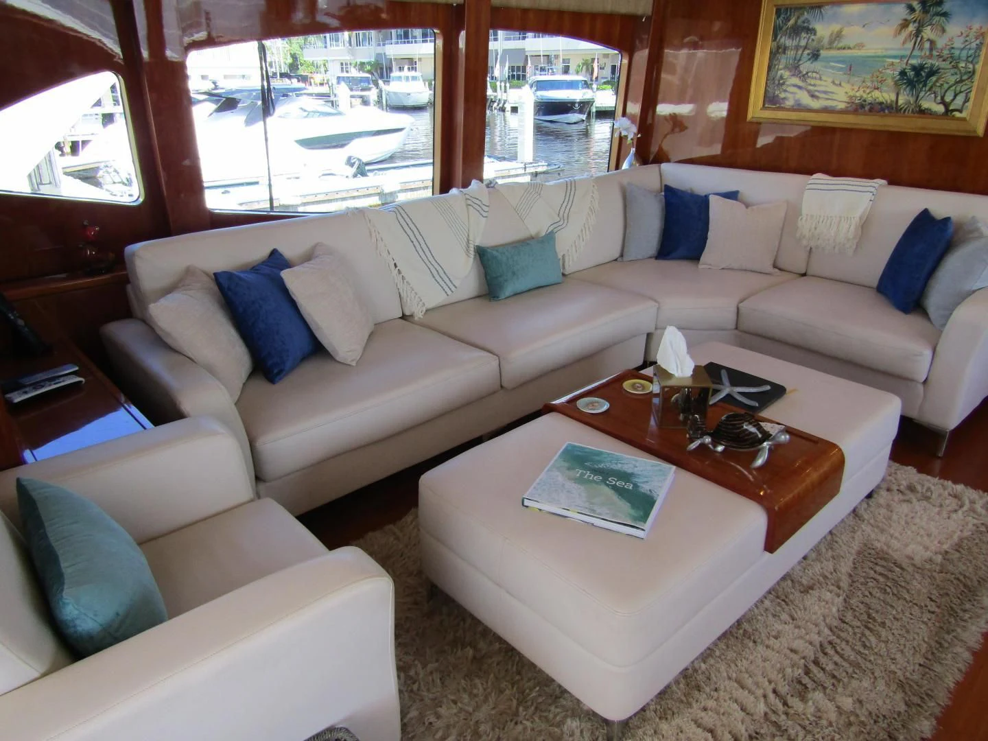 a living room with a couch and a coffee table aboard LADY C II Yacht for Sale