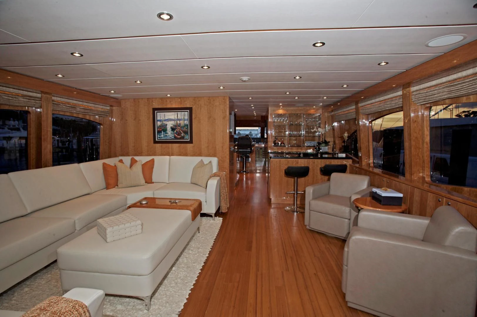 a living room with a large wood floor aboard LADY C II Yacht for Sale