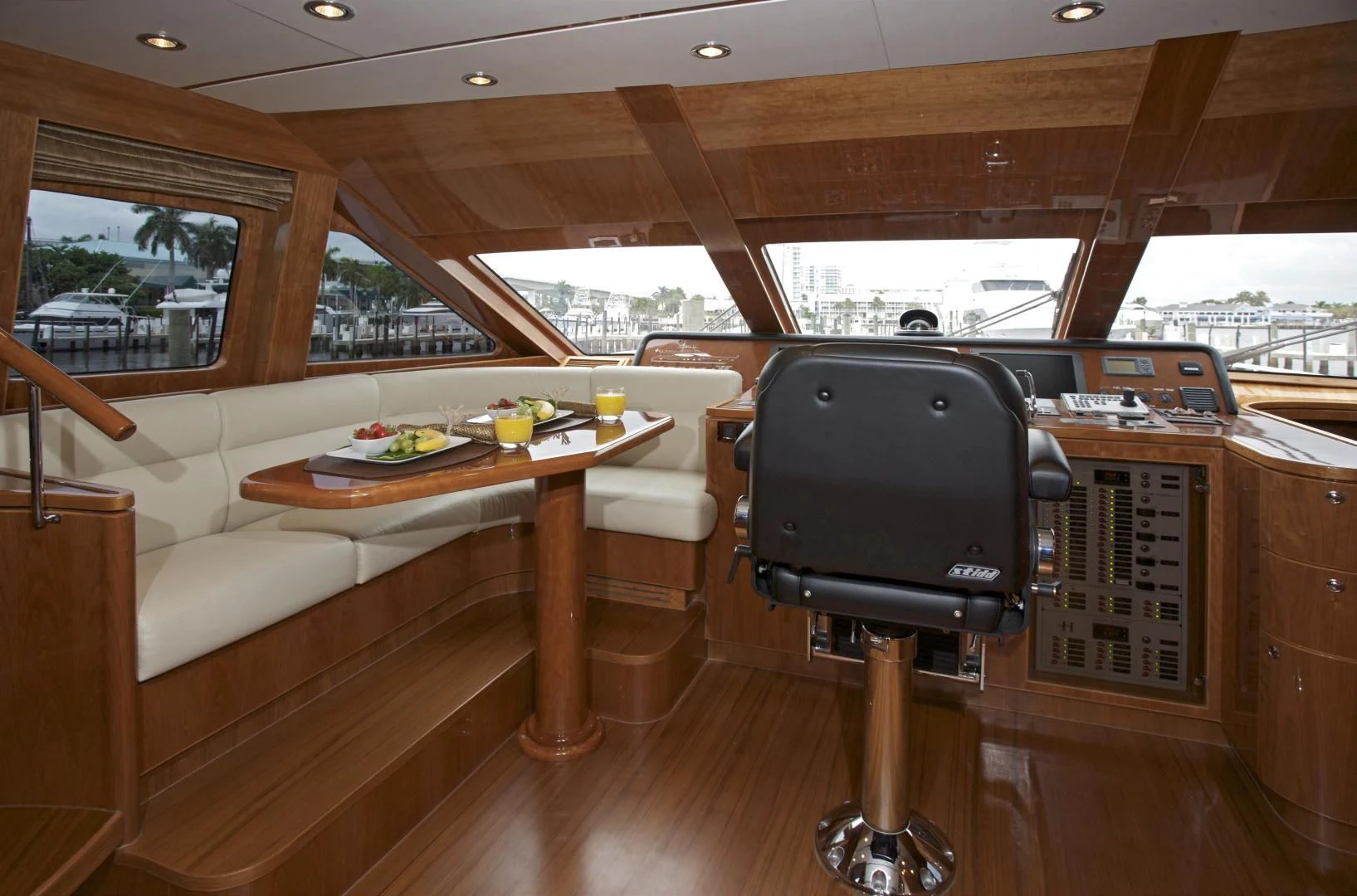 a living room with a tv and a table aboard LADY C II Yacht for Sale