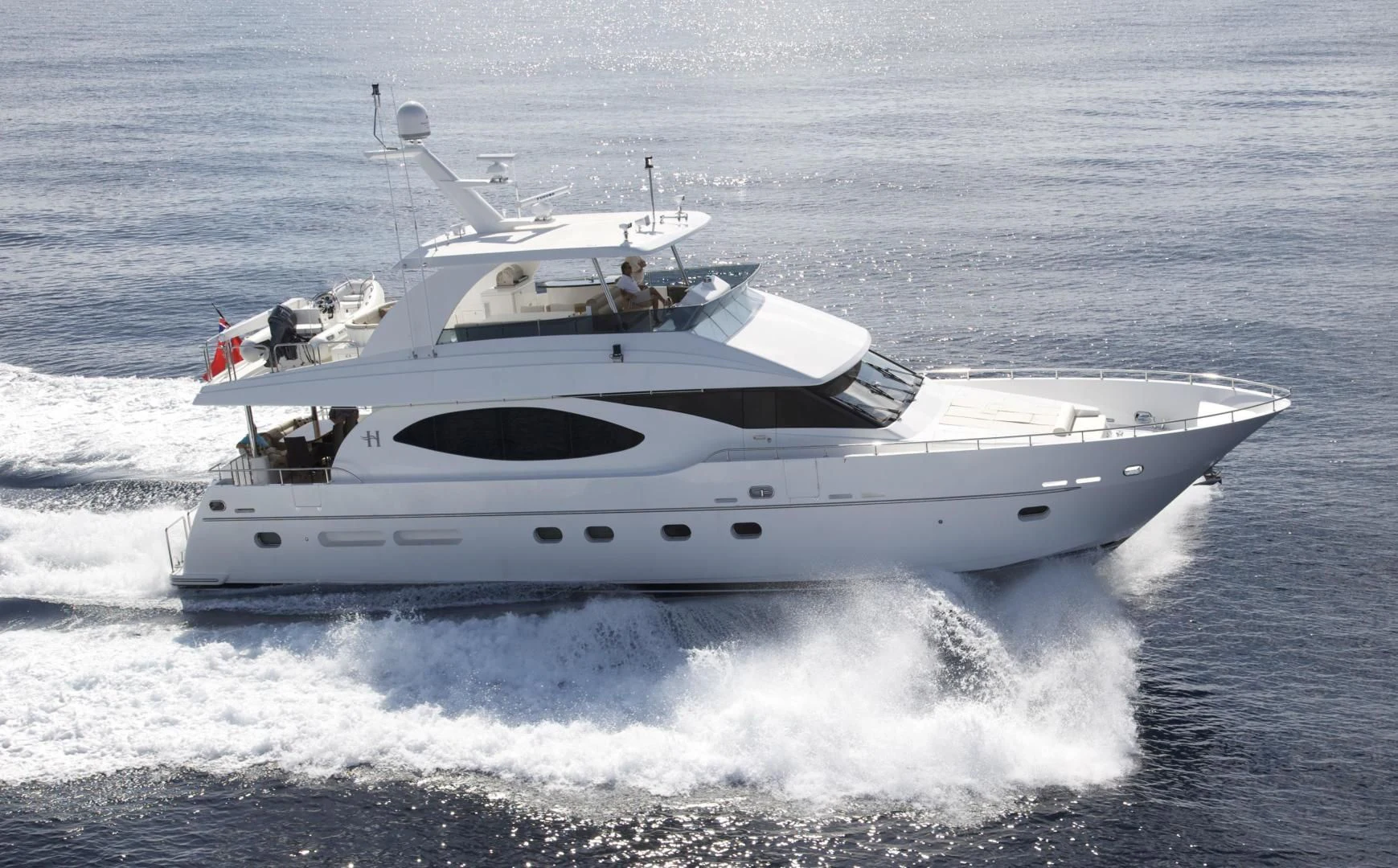 a white yacht with a couple of people on it aboard LADY C II Yacht for Sale
