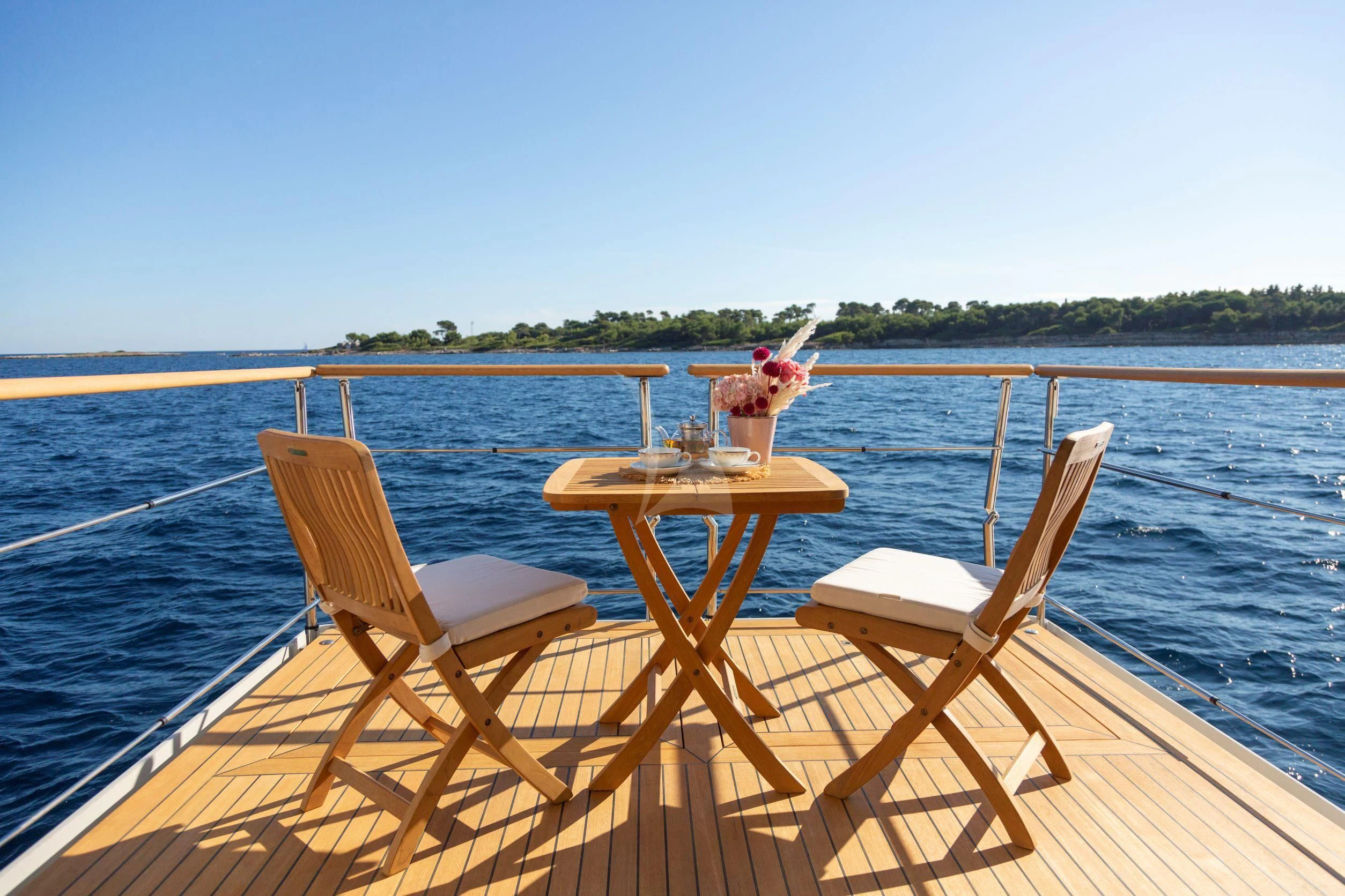a table and chairs on a boat aboard MARAYA Yacht for Sale