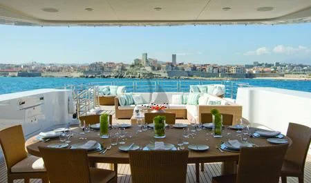 a table set for a dinner party aboard MARAYA Yacht for Sale