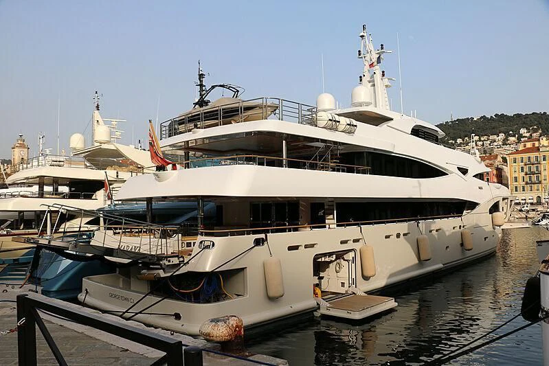 a large white boat in a harbor aboard MARAYA Yacht for Sale