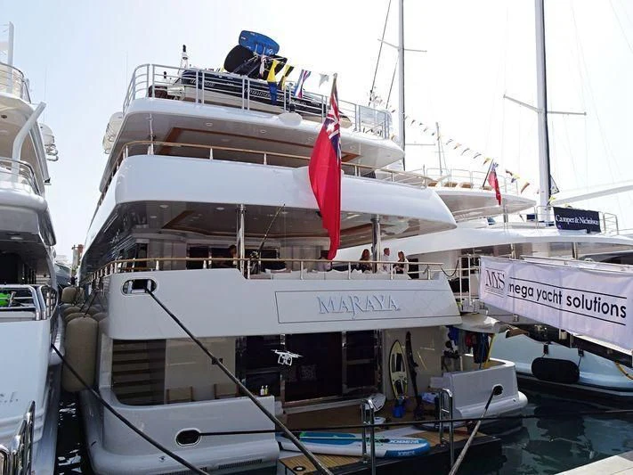 a large white boat with a red stripe on the front aboard MARAYA Yacht for Sale