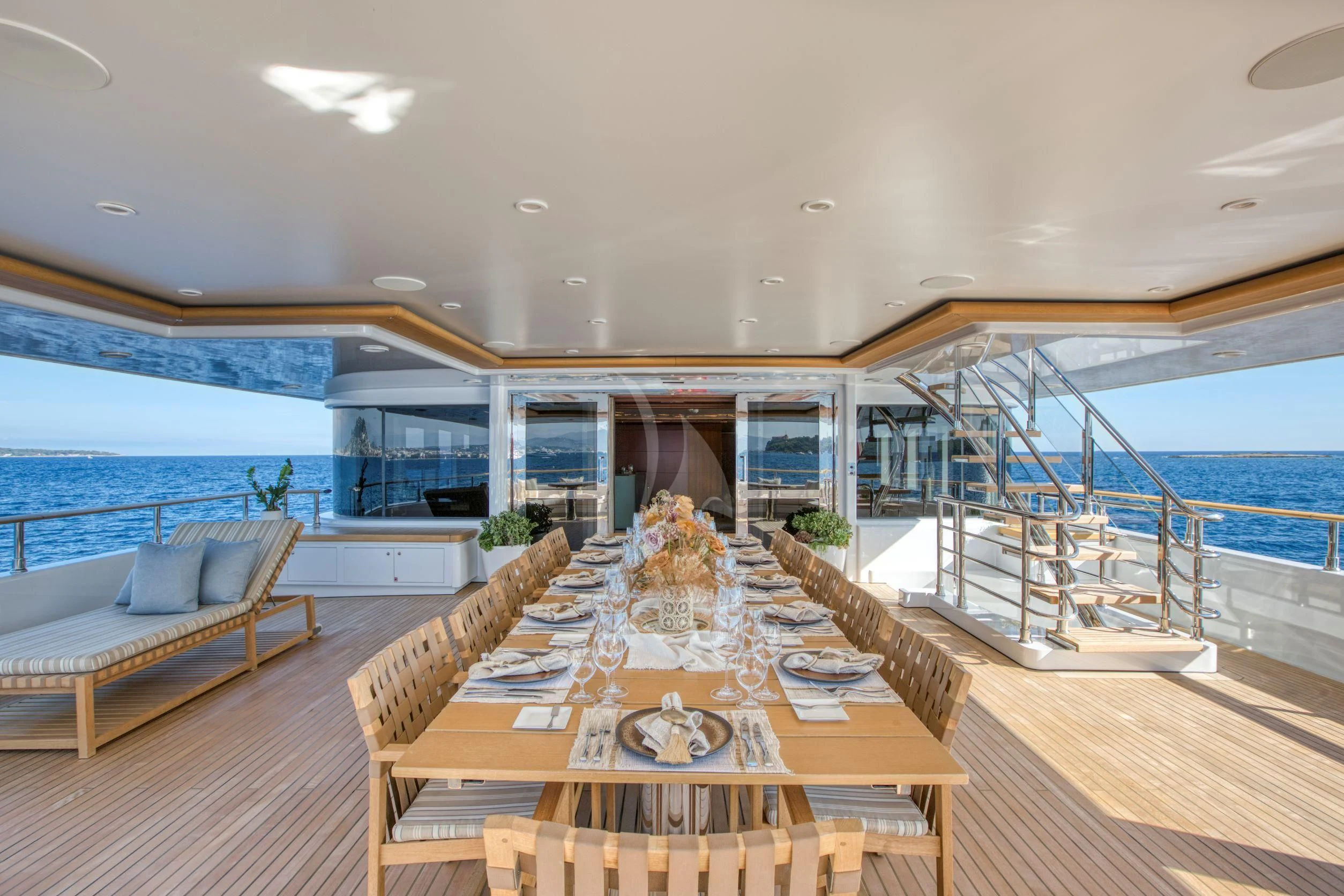 a large living room with a large balcony overlooking the ocean aboard MARAYA Yacht for Sale