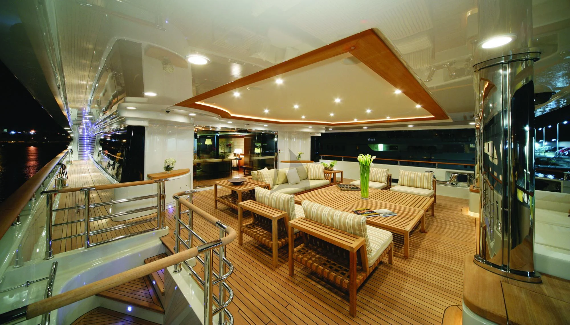 a large living room with a wood floor and white couches aboard MARAYA Yacht for Sale