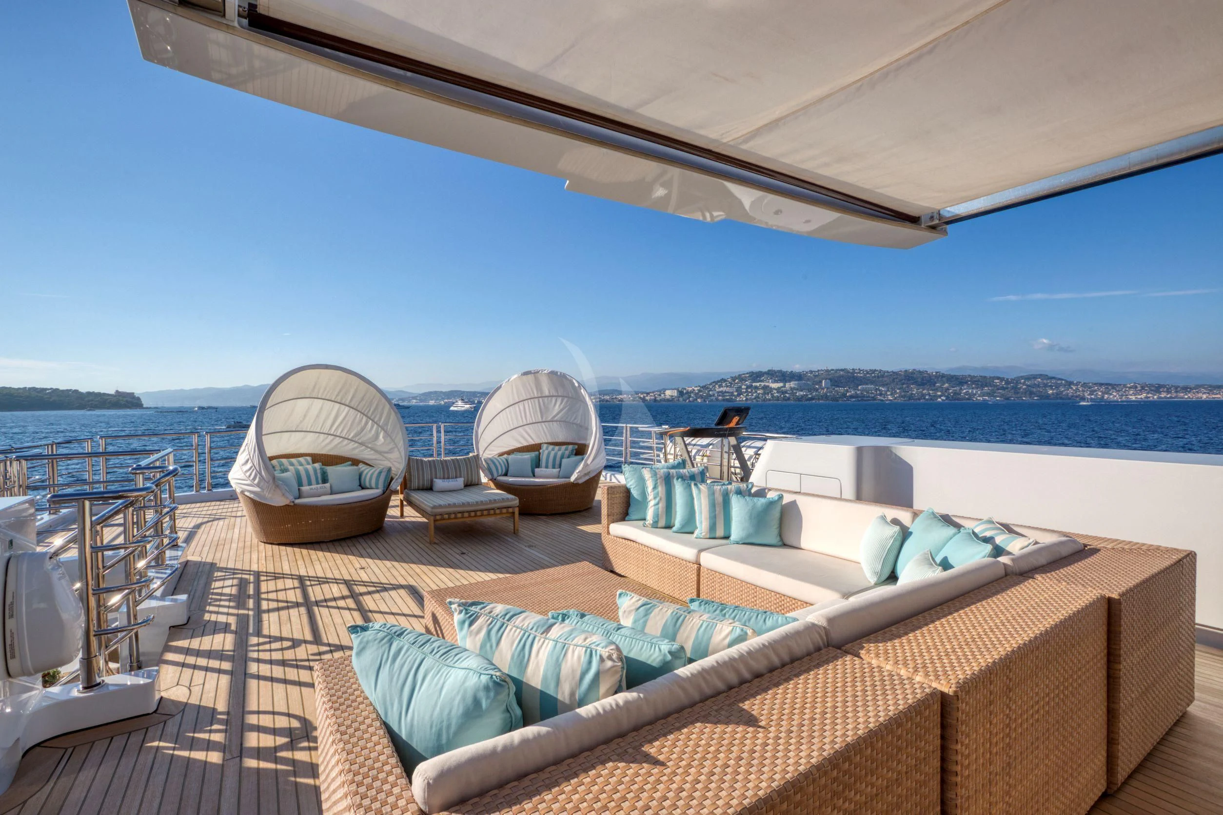 a large lounge chair on a deck overlooking the ocean aboard MARAYA Yacht for Sale