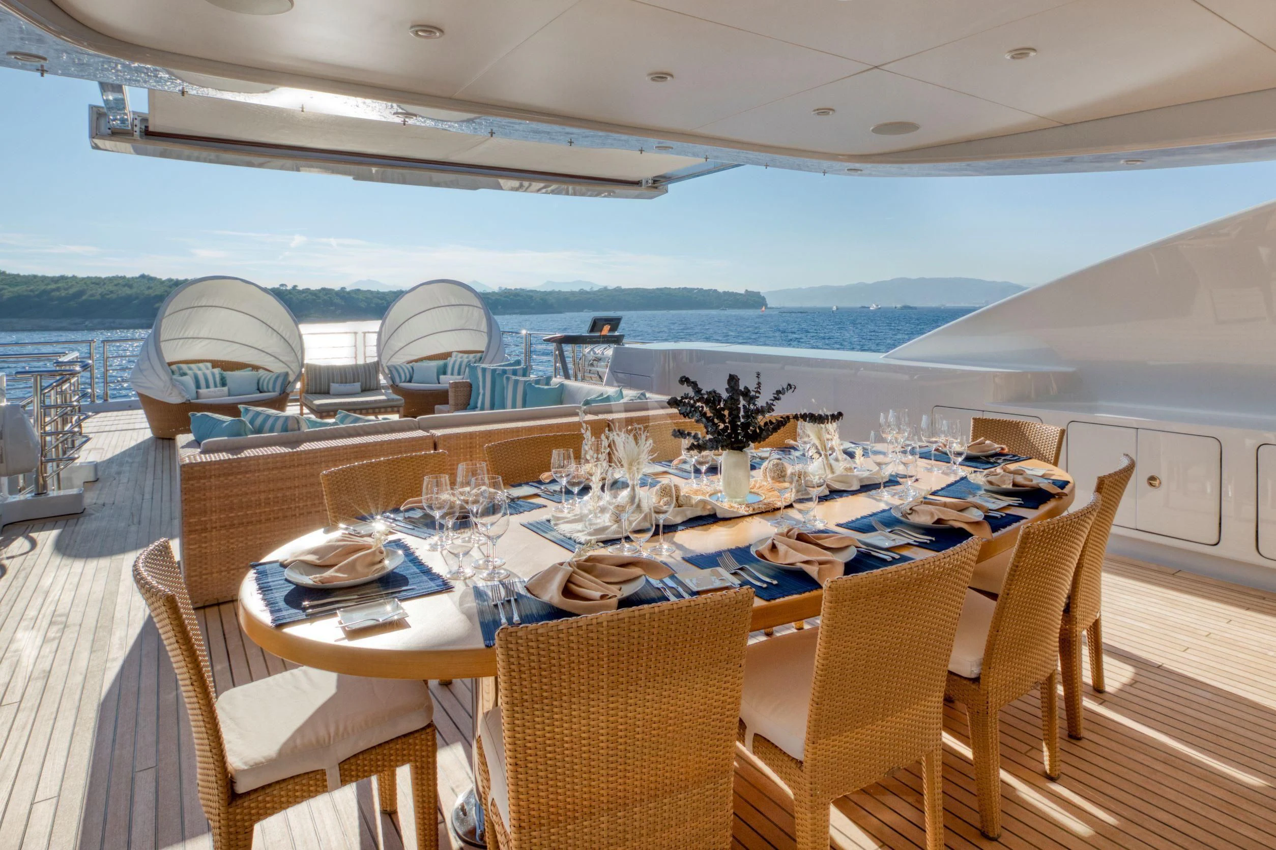 a table set for a meal on a deck aboard MARAYA Yacht for Sale