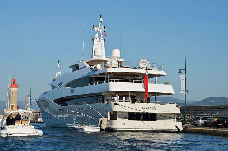 a large white boat with a lighthouse on the water aboard MARAYA Yacht for Sale