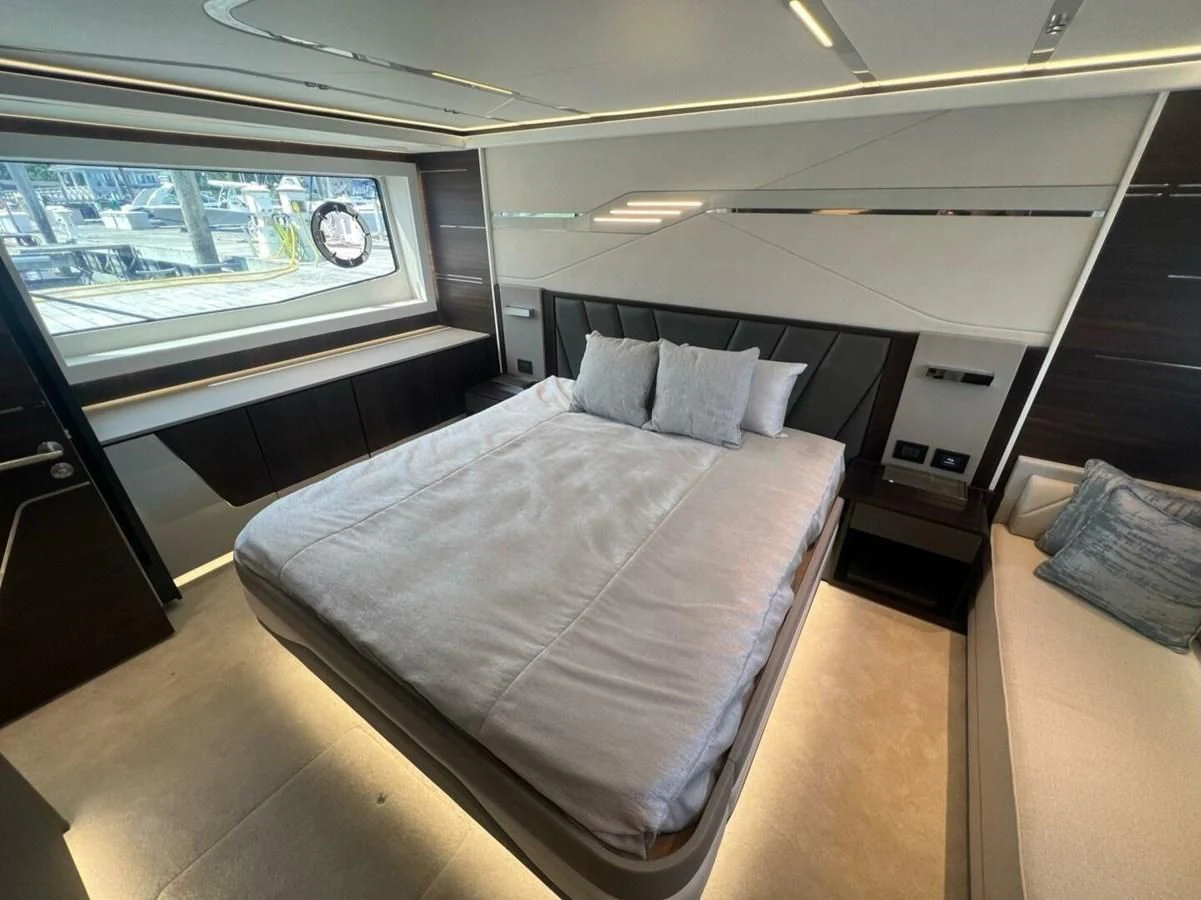 a room with a bed and a window aboard 75 SPORT YACHT Yacht for Sale