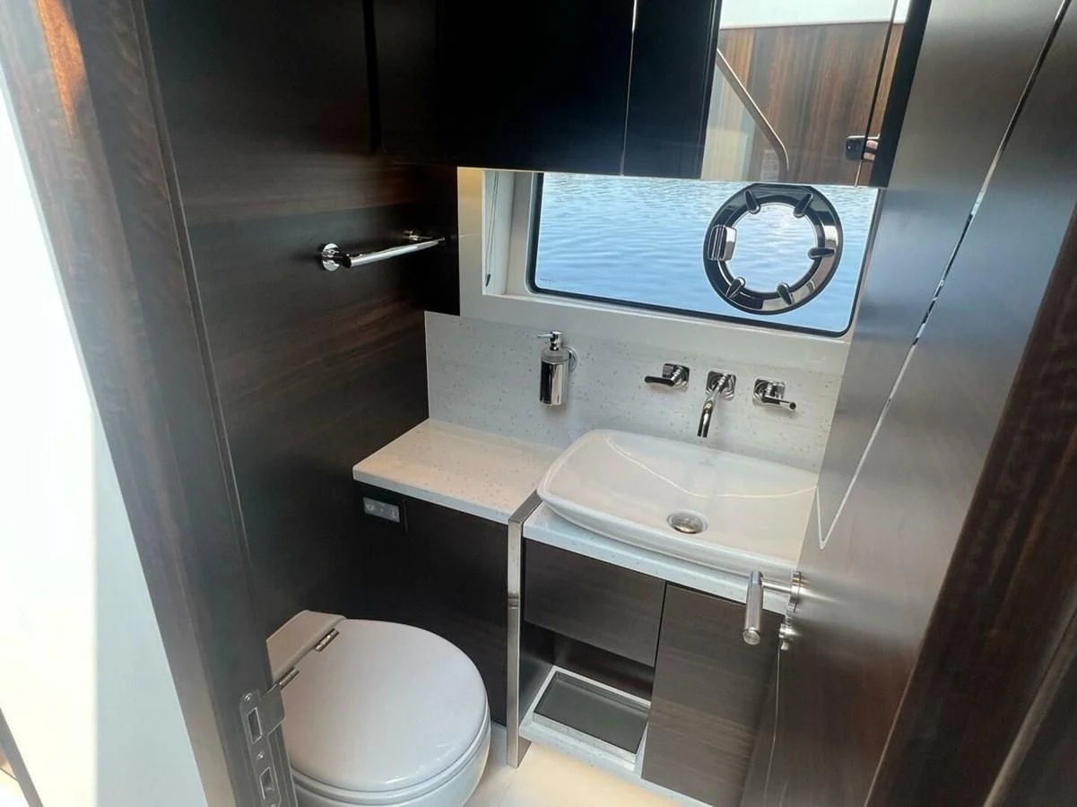 a bathroom with a sink and a toilet aboard 75 SPORT YACHT Yacht for Sale