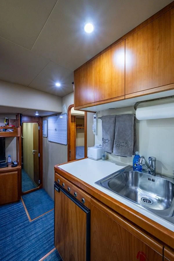a kitchen with a sink and cabinets aboard EVERYTHING GOOD Yacht for Sale
