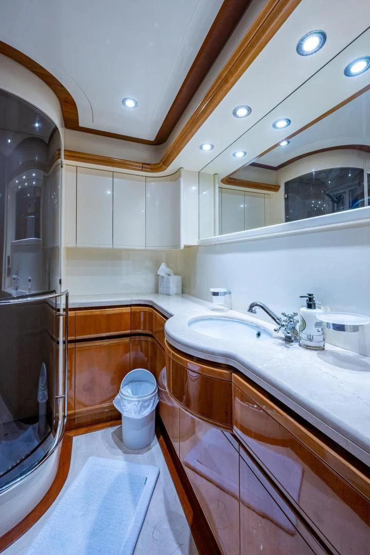 a bathroom with a sink and a large mirror aboard EVERYTHING GOOD Yacht for Sale