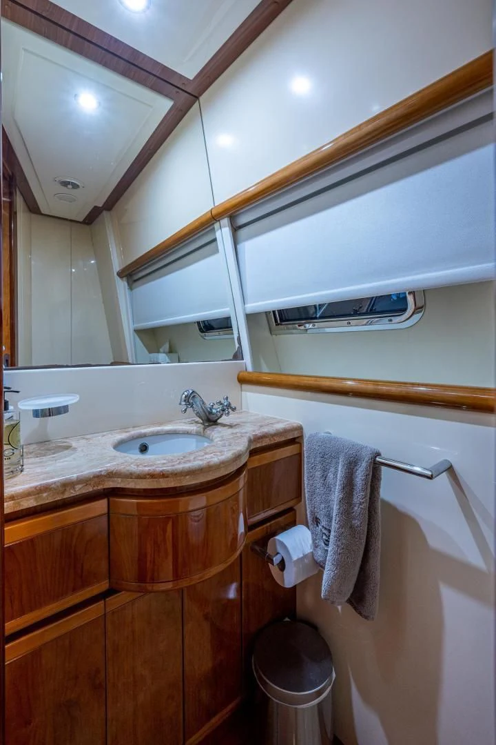 a bathroom with a sink and a mirror aboard EVERYTHING GOOD Yacht for Sale