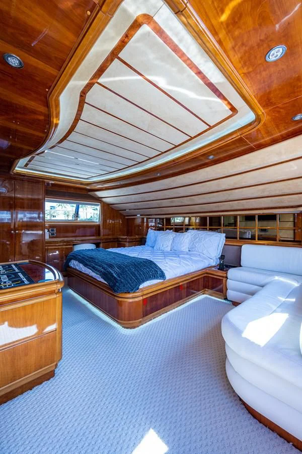 a room with a bed and a couch aboard EVERYTHING GOOD Yacht for Sale