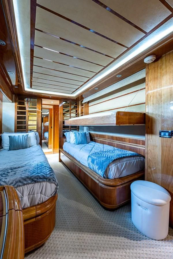 a room with a bed and a chair aboard EVERYTHING GOOD Yacht for Sale