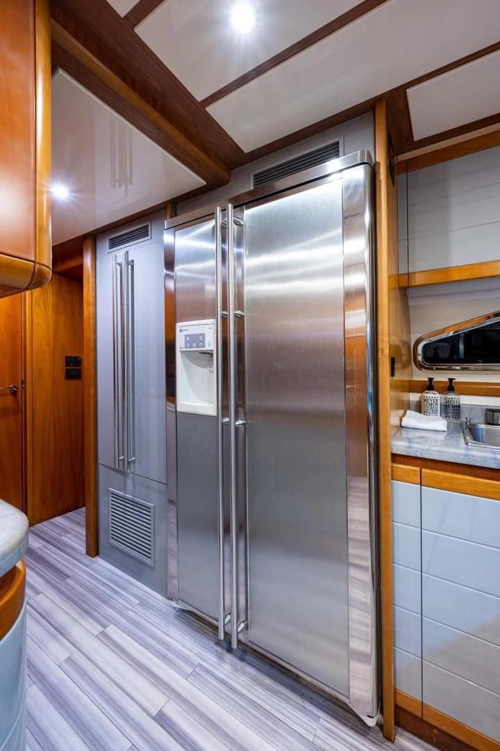 a stainless steel refrigerator in a kitchen aboard EVERYTHING GOOD Yacht for Sale