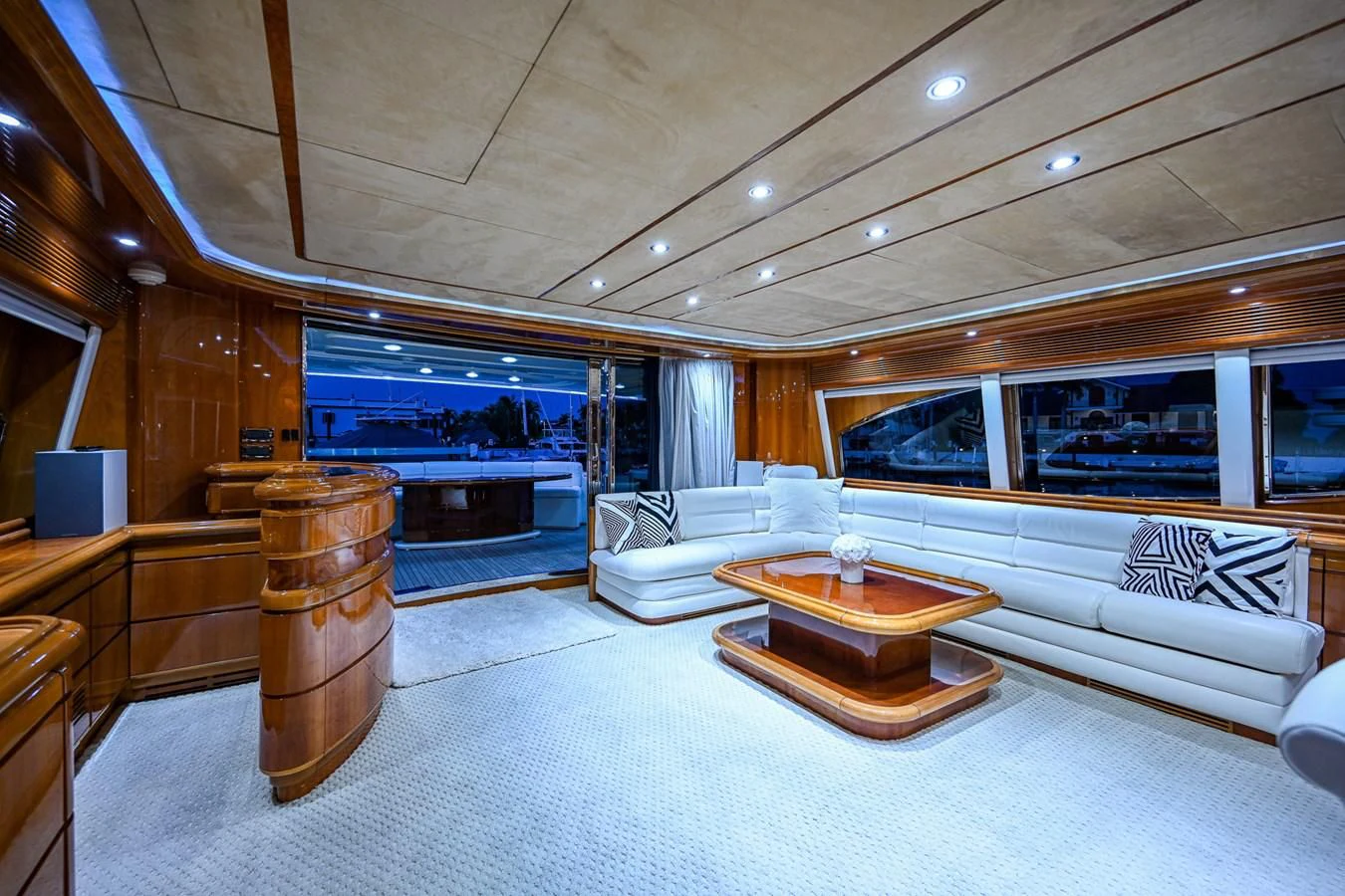 a living room with a large wood table and a large window aboard EVERYTHING GOOD Yacht for Sale