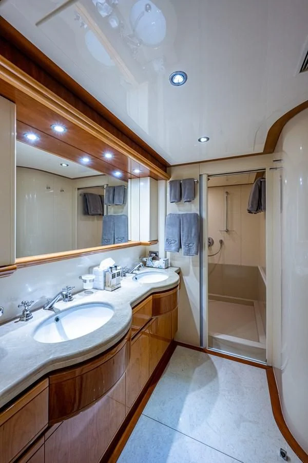 a bathroom with a large mirror aboard EVERYTHING GOOD Yacht for Sale