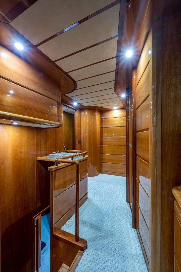 a room with wooden walls and a desk with a blue carpet aboard EVERYTHING GOOD Yacht for Sale