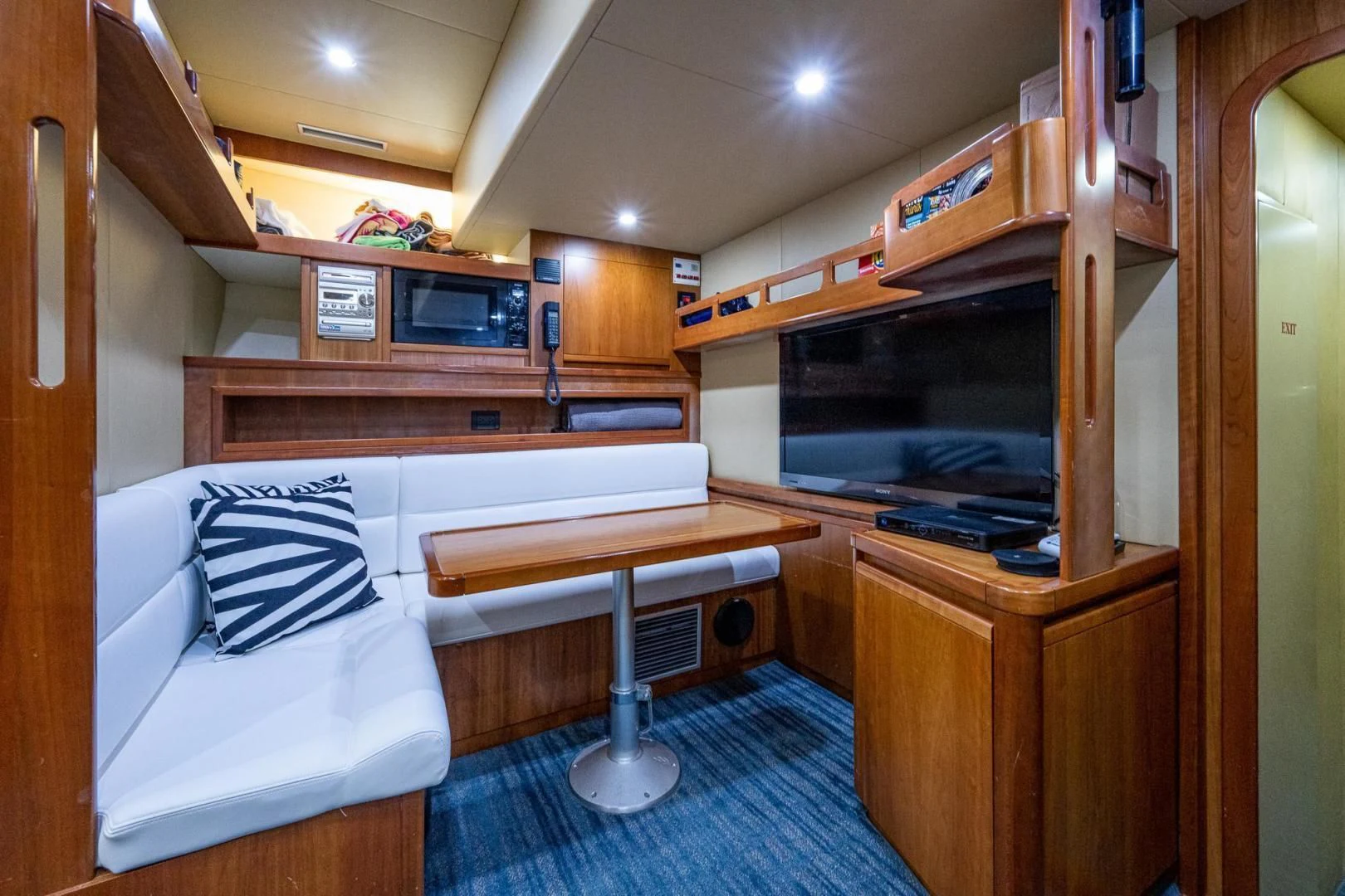 a bedroom with a bed and a table aboard EVERYTHING GOOD Yacht for Sale
