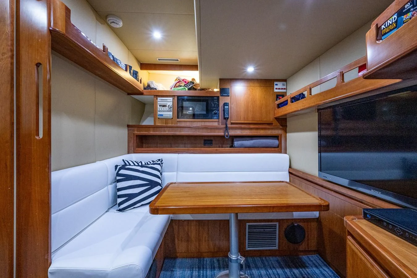 a room with a table and a couch aboard EVERYTHING GOOD Yacht for Sale