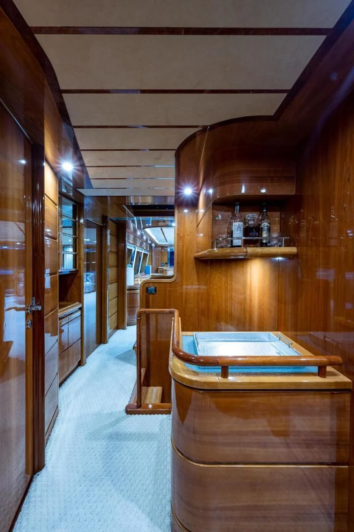 a room with wooden walls and wood furniture aboard EVERYTHING GOOD Yacht for Sale