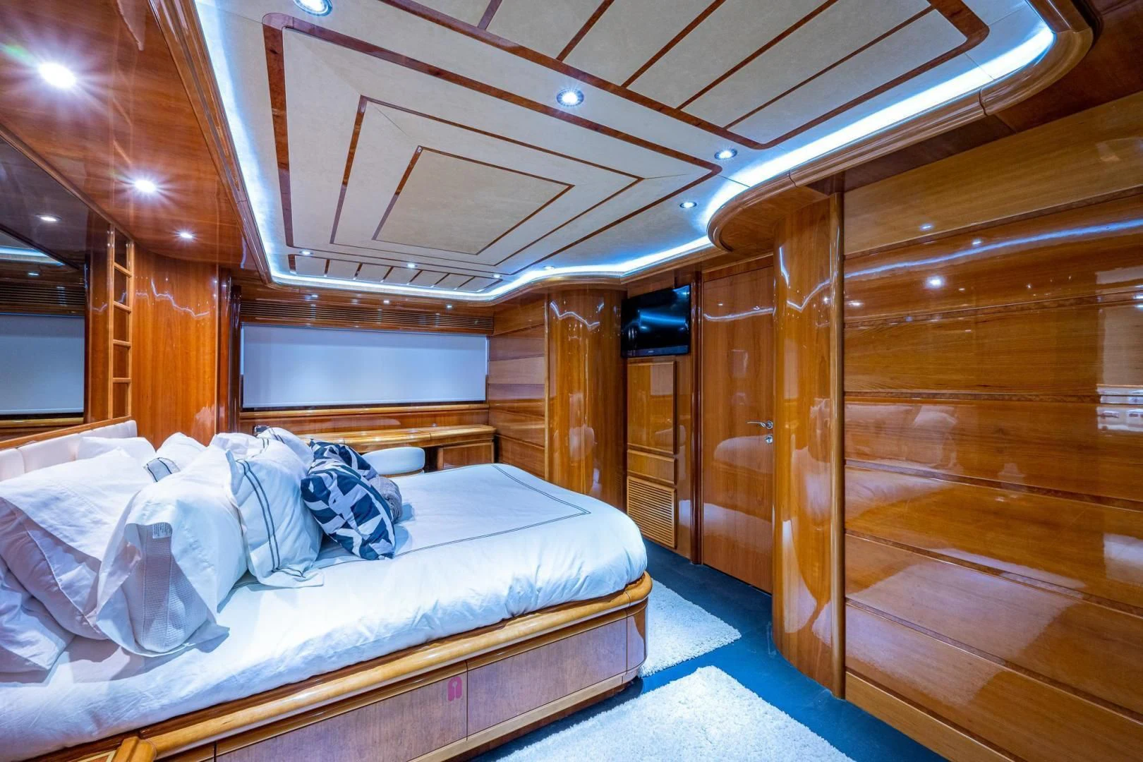 a room with a bed and a mirror aboard EVERYTHING GOOD Yacht for Sale