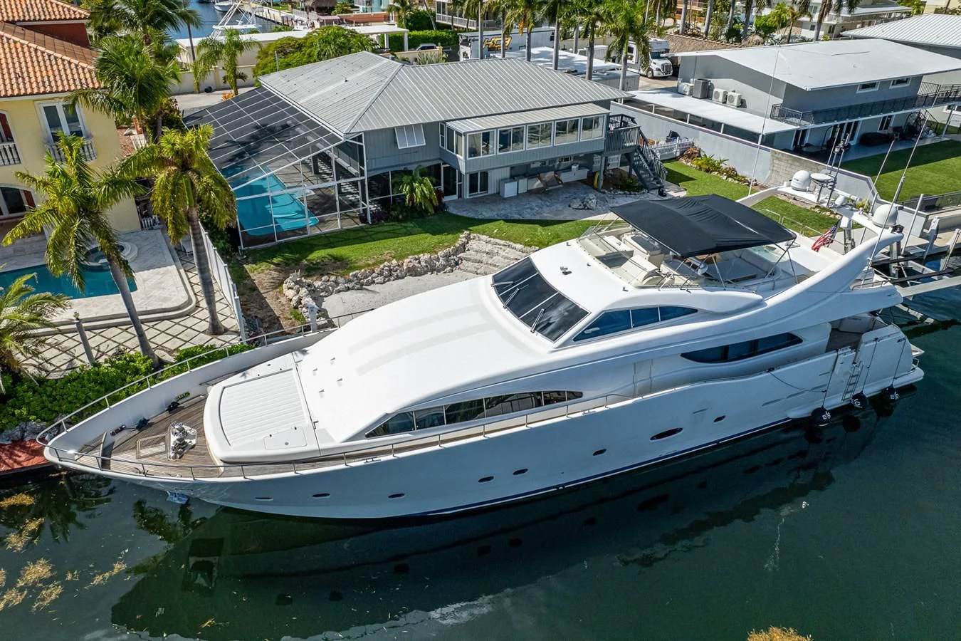 a white yacht docked in a harbor aboard EVERYTHING GOOD Yacht for Sale
