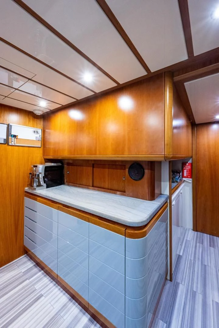 a kitchen with wooden cabinets aboard EVERYTHING GOOD Yacht for Sale