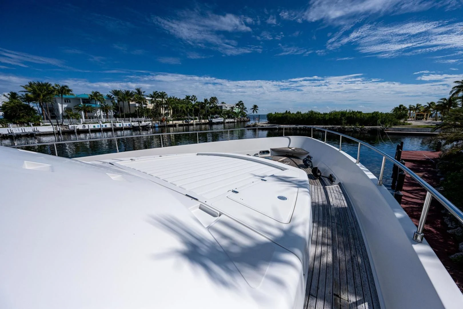 a large pool with a railing and trees in the background aboard EVERYTHING GOOD Yacht for Sale