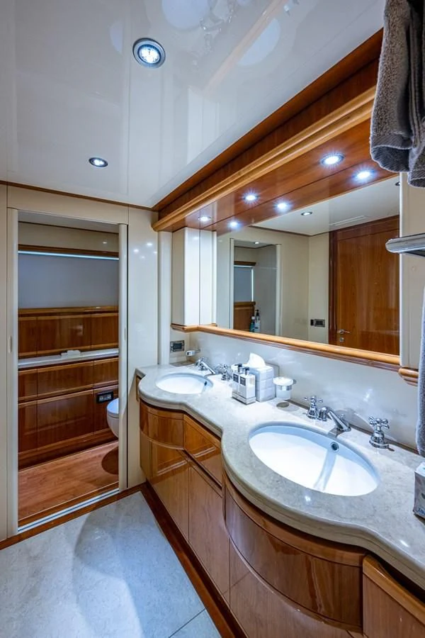 a bathroom with a large mirror aboard EVERYTHING GOOD Yacht for Sale
